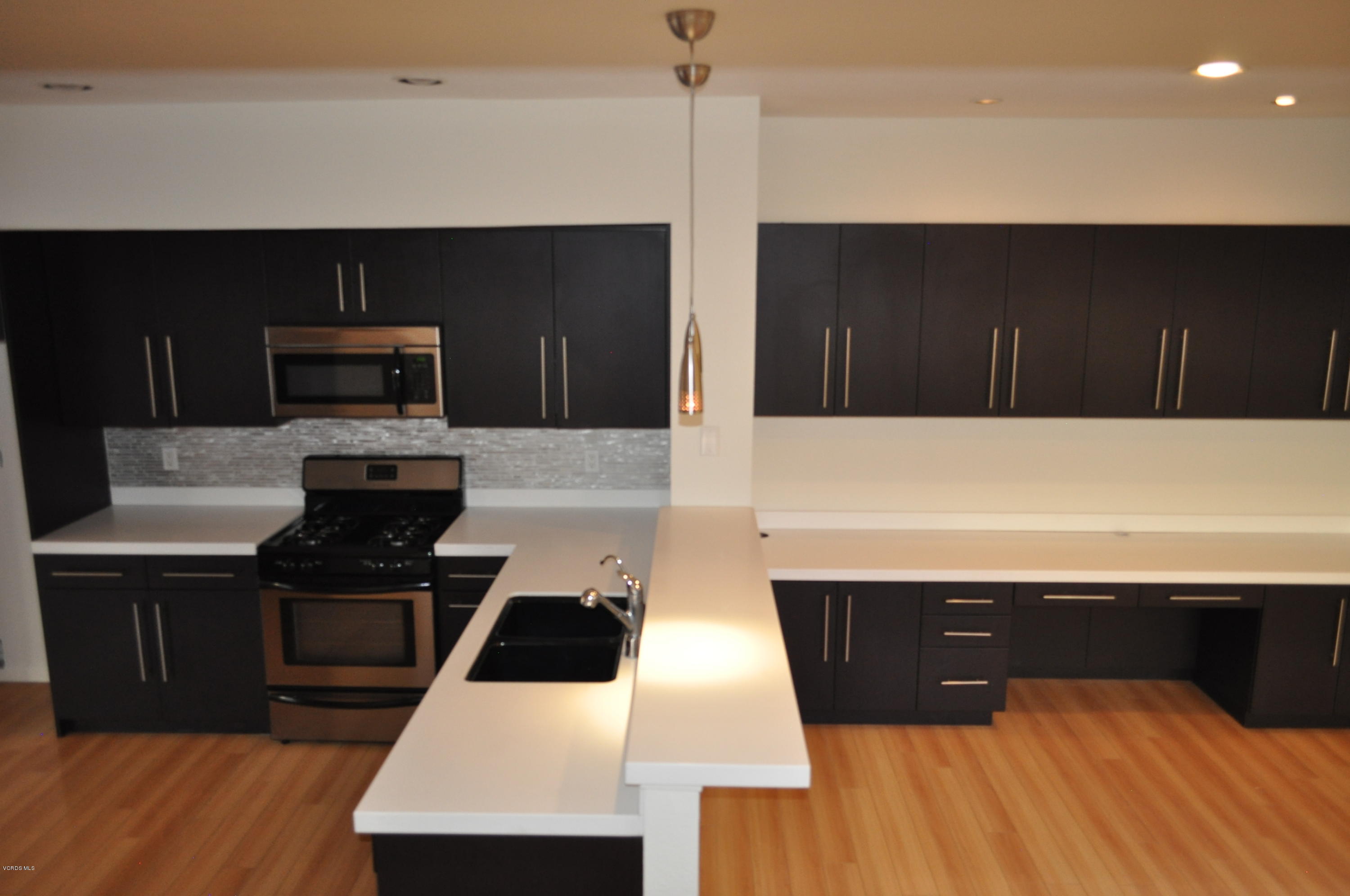 4852 Penrose Avenue Moorpark, CA 93021 - Photo 5 of 20 a kitchen with a sink and a refrigerator