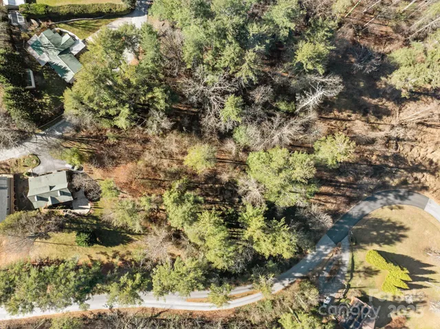 a backyard of a house with lots of trees