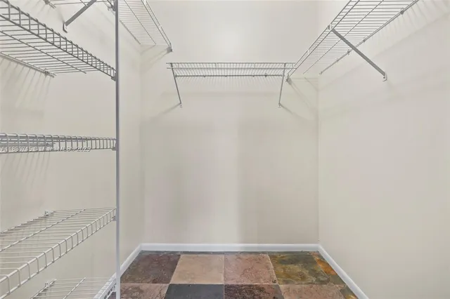 a bathroom with a shower a mirror and a sink