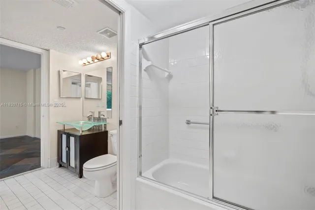 a bathroom with a glass shower door