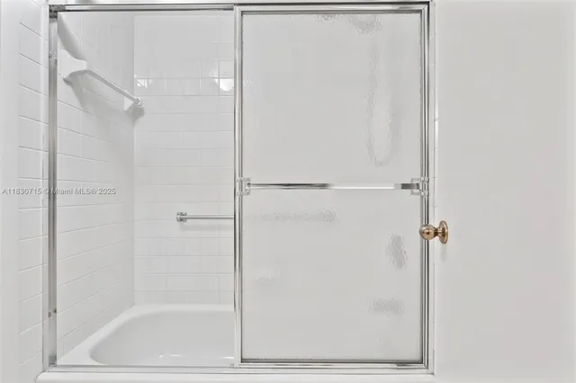 a bathroom with a granite countertop sink a toilet a mirror and shower