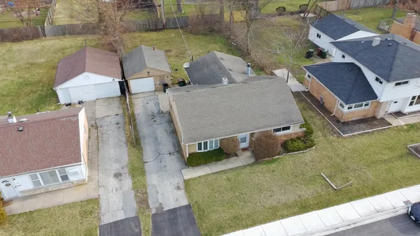 an aerial view of a house with a yard