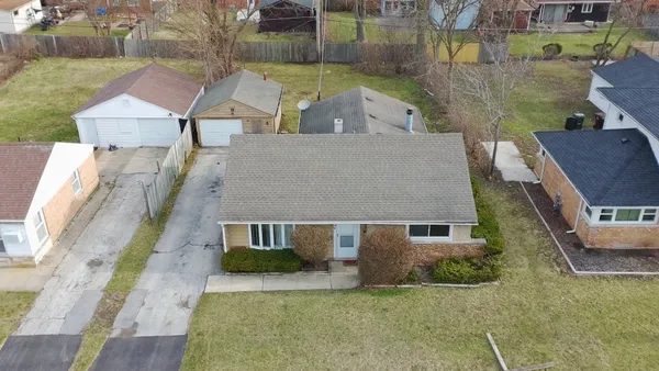 an aerial view of a house with a yard