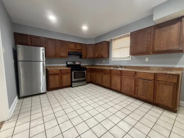 a kitchen with stainless steel appliances granite countertop a refrigerator sink and cabinets