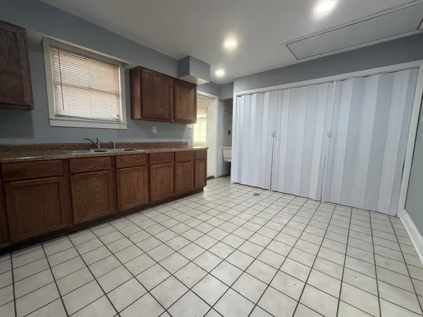 a large kitchen with a sink and cabinets