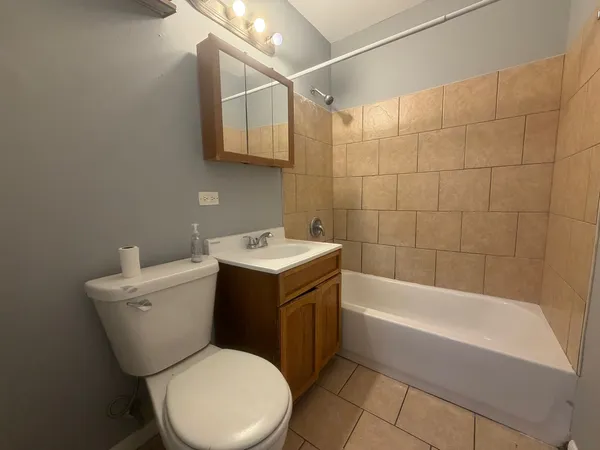 a bathroom with a sink mirror vanity and toilet