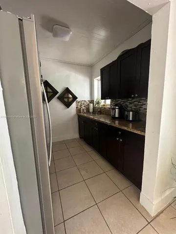 a kitchen with a sink and a stove top oven