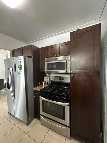 a kitchen with a refrigerator and a stove