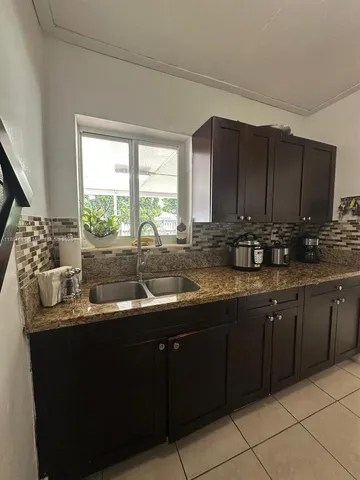 a kitchen with a sink and a window