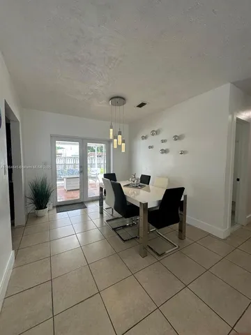 a living room with furniture and dining table