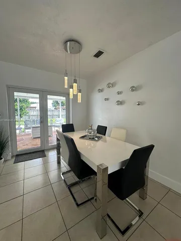 a view of a dining room with furniture and window