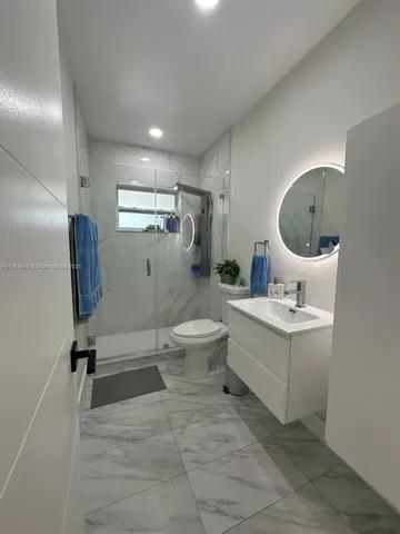 a bathroom with a sink toilet and shower
