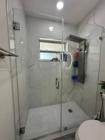 a bathroom with a shower and toilet