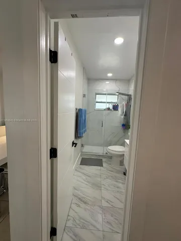 a bathroom with a shower and a toilet