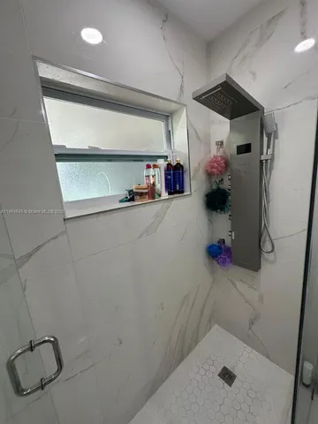 a bathroom with a tub and shower