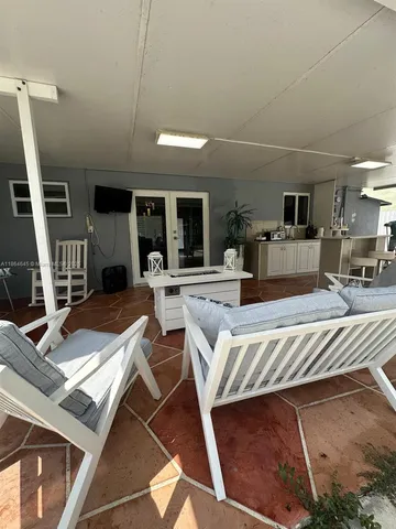 a room with furniture a rug and white walls