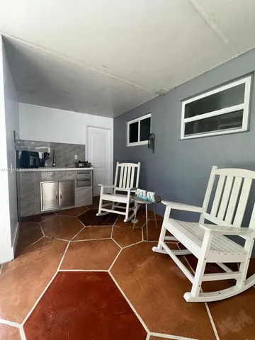 a room with a chair and white walls
