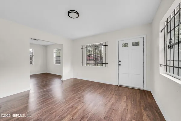 a view of kitchen with furniture and wooden floor