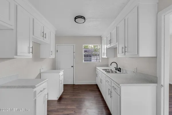 a kitchen with stainless steel appliances granite countertop a sink and a stove top oven