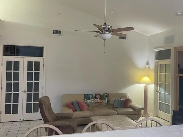 a living room with furniture and a ceiling fan