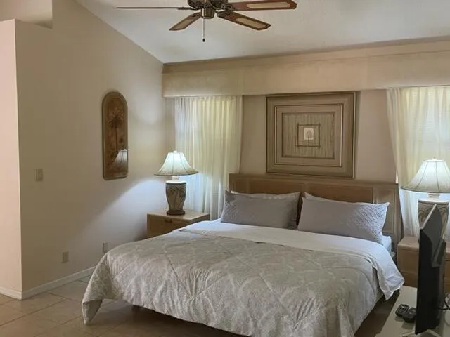 a bedroom with a bed and a lamp