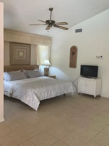 a bedroom with a bed a couch and dresser