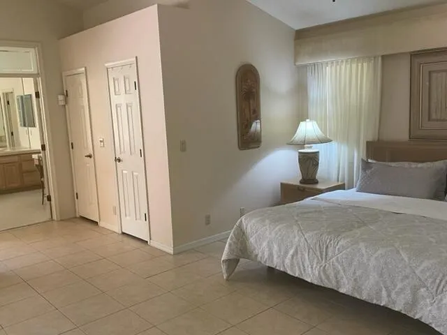 a bedroom with a bed and a lamp