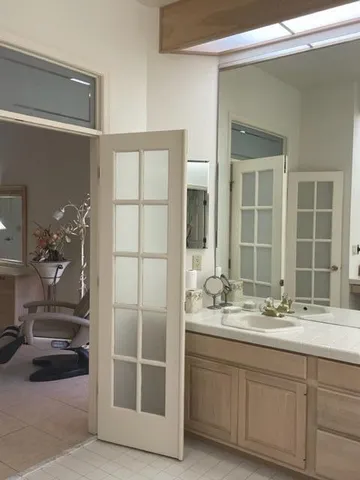a bathroom with a double vanity sink and a mirror