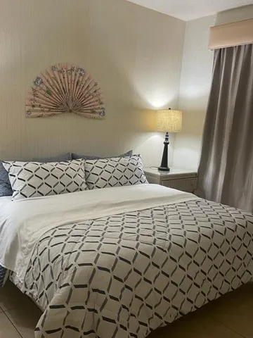 a bedroom with a bed and a painting on the wall