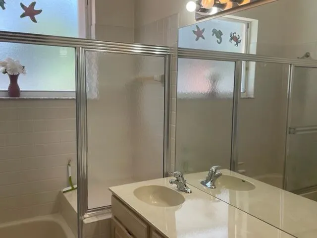 a bathroom with a sink and shower
