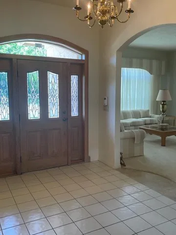 a kitchen with a cabinets and chandelier