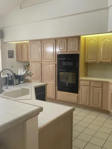 a kitchen with stainless steel appliances a sink and cabinets