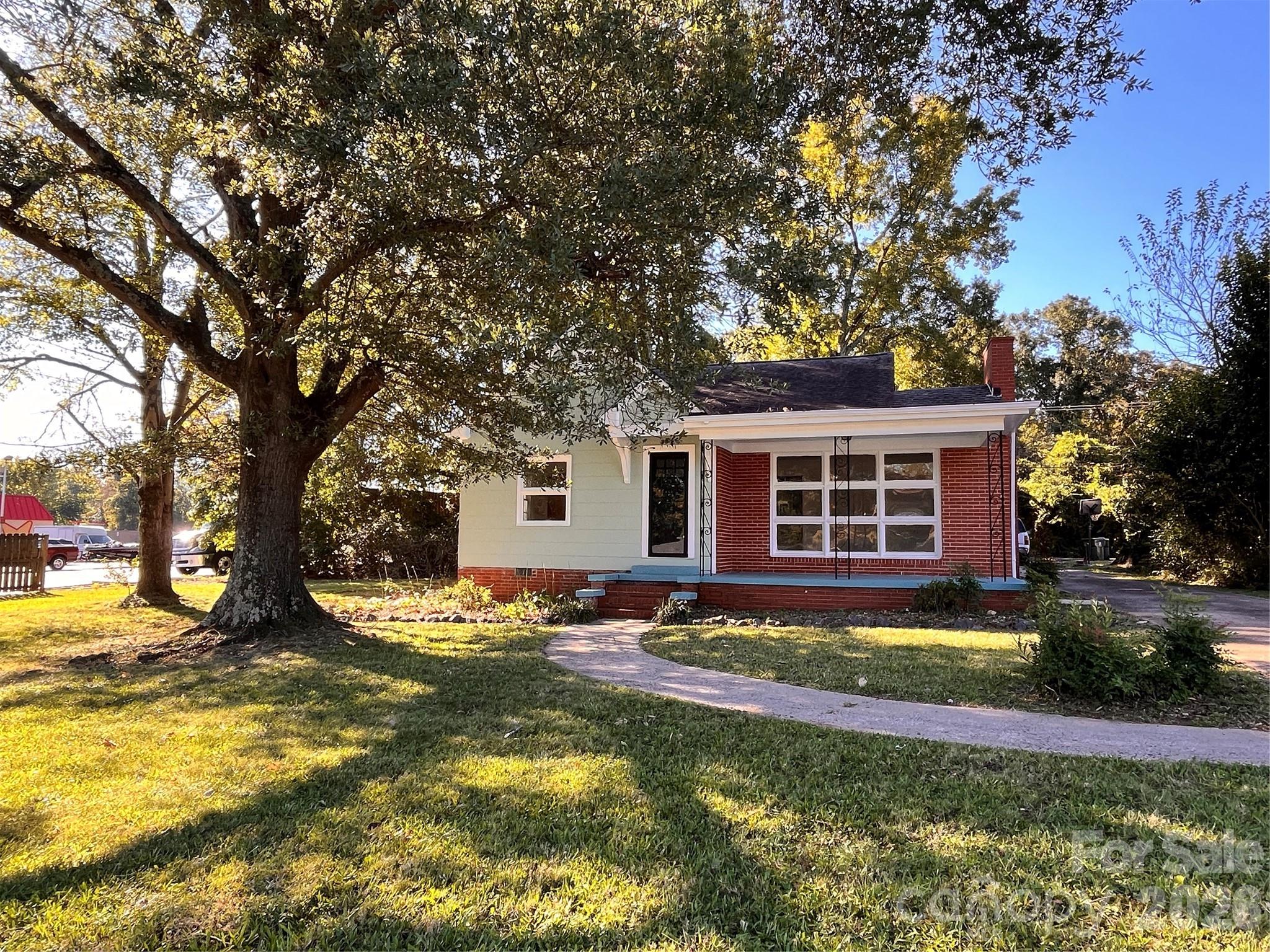 704 McAdenville Road Lowell, NC 28098 - Photo 13 of 14 a view of a house with swimming pool and sitting area