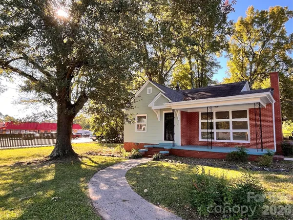 a view of a house with backyard porch and sitting area
