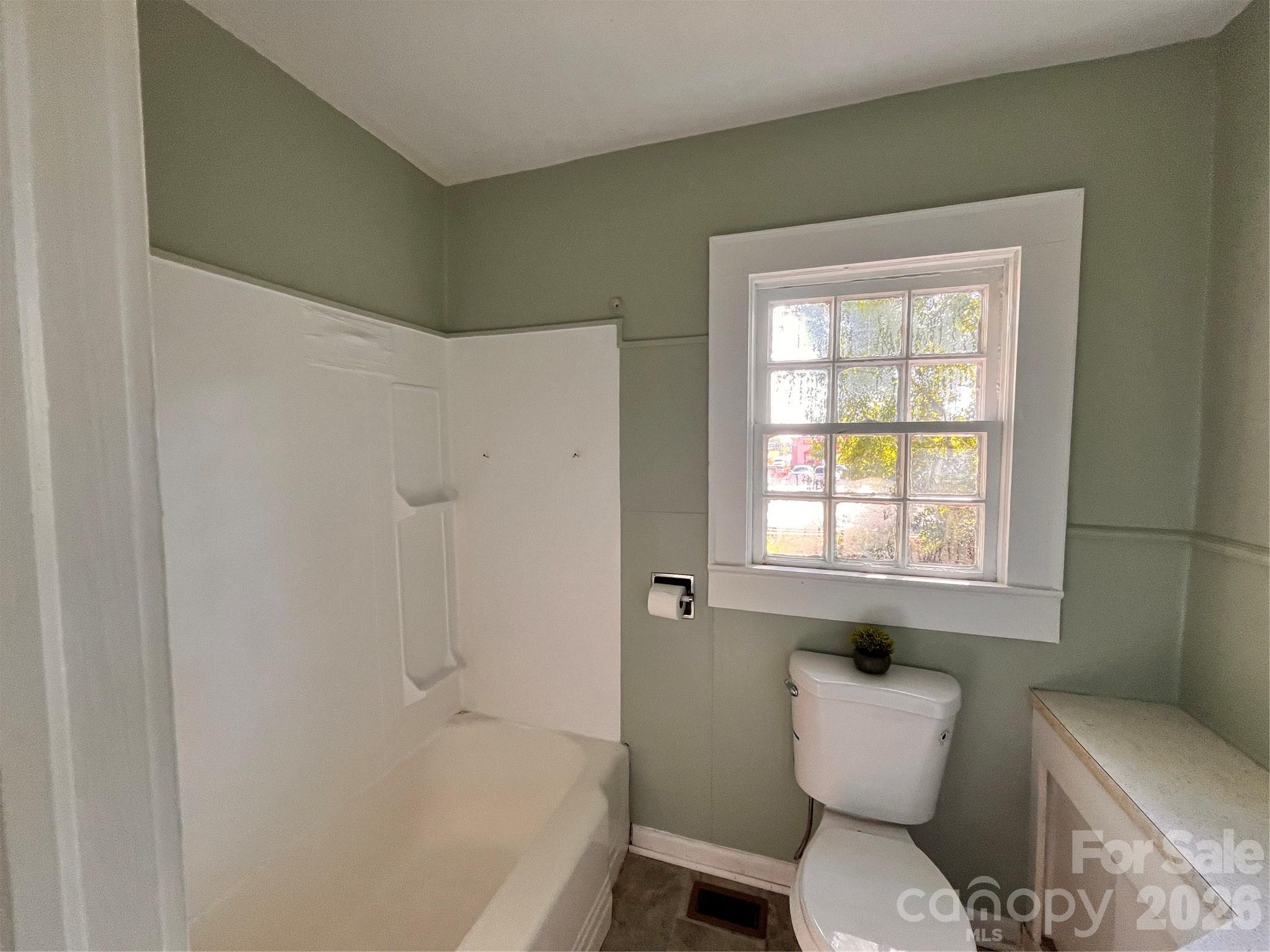 704 McAdenville Road Lowell, NC 28098 - Photo 7 of 14 a bathroom with a toilet sink and bathtub