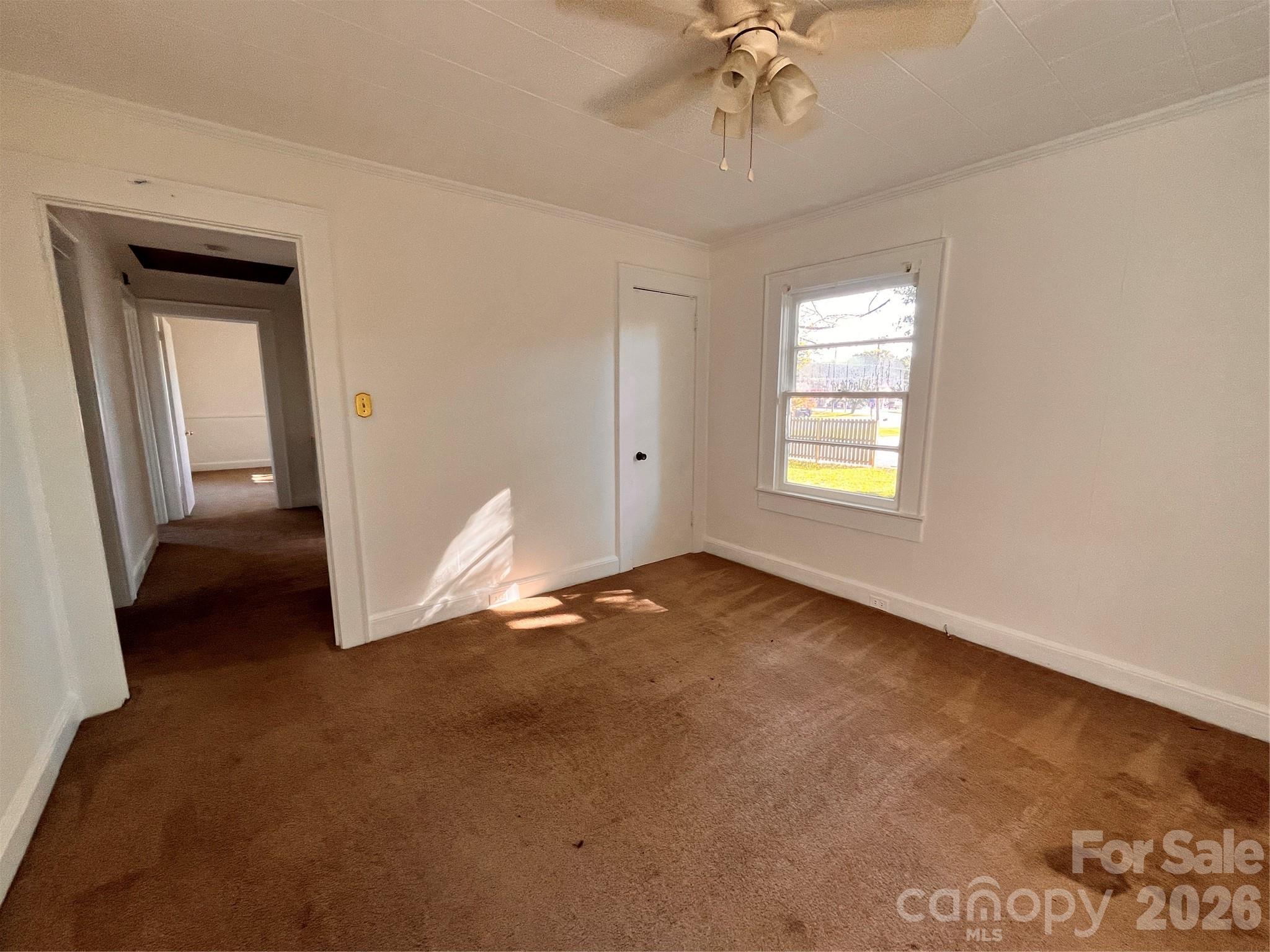 704 McAdenville Road Lowell, NC 28098 - Photo 8 of 14 a view of an empty room with a window