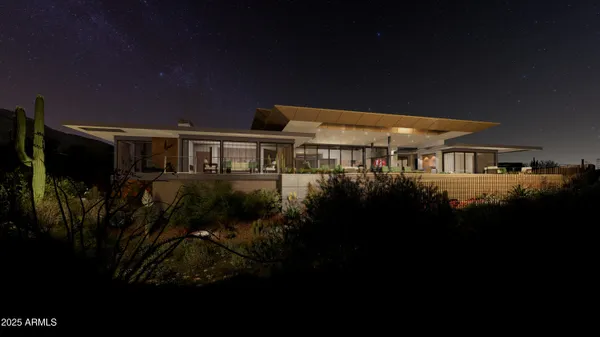 a view of a patio with table and chairs under an umbrella