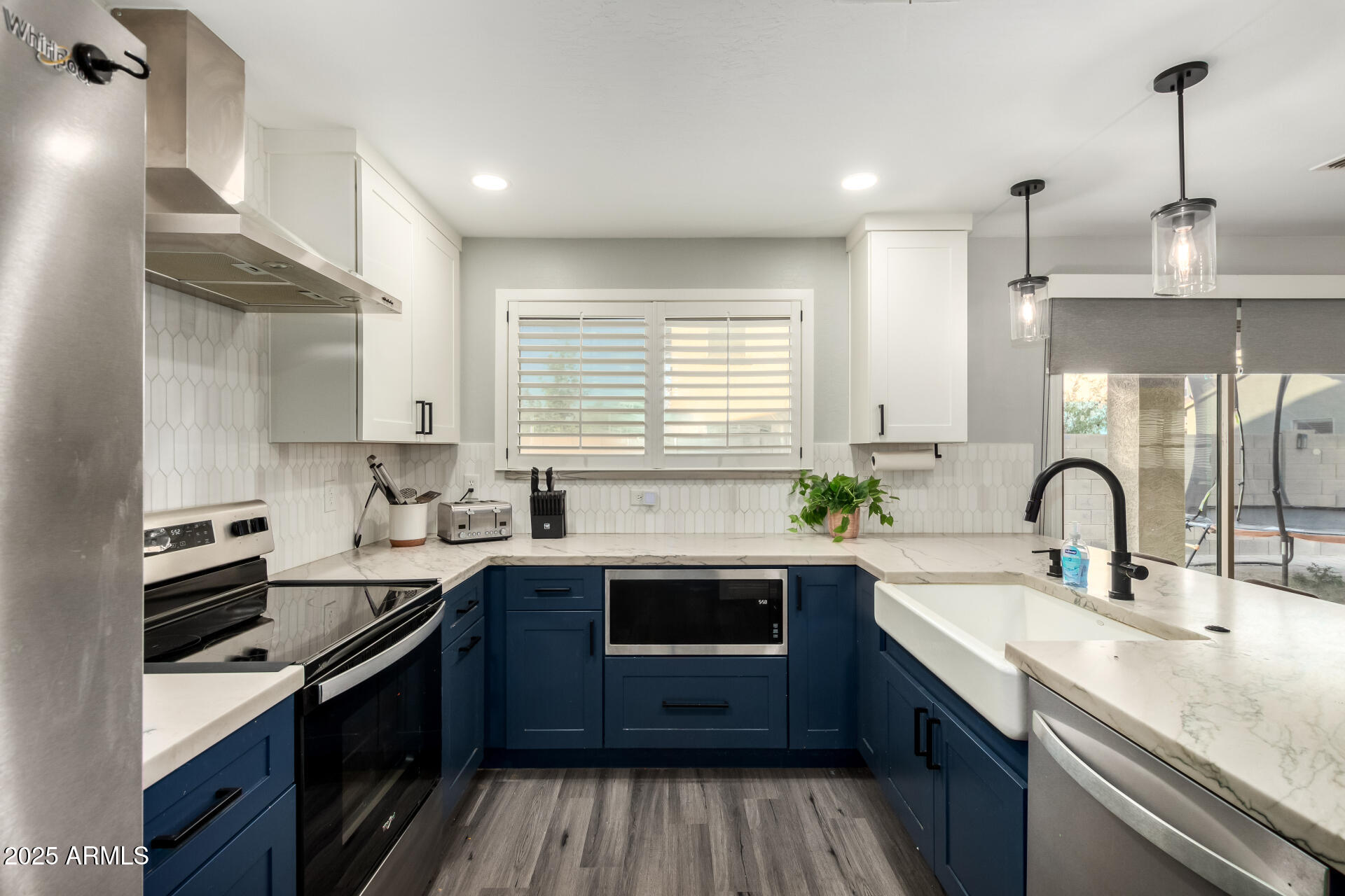 9415 West Eaton Road Phoenix, AZ 85037 - Photo 15 of 36 a kitchen with a sink and a stove top oven