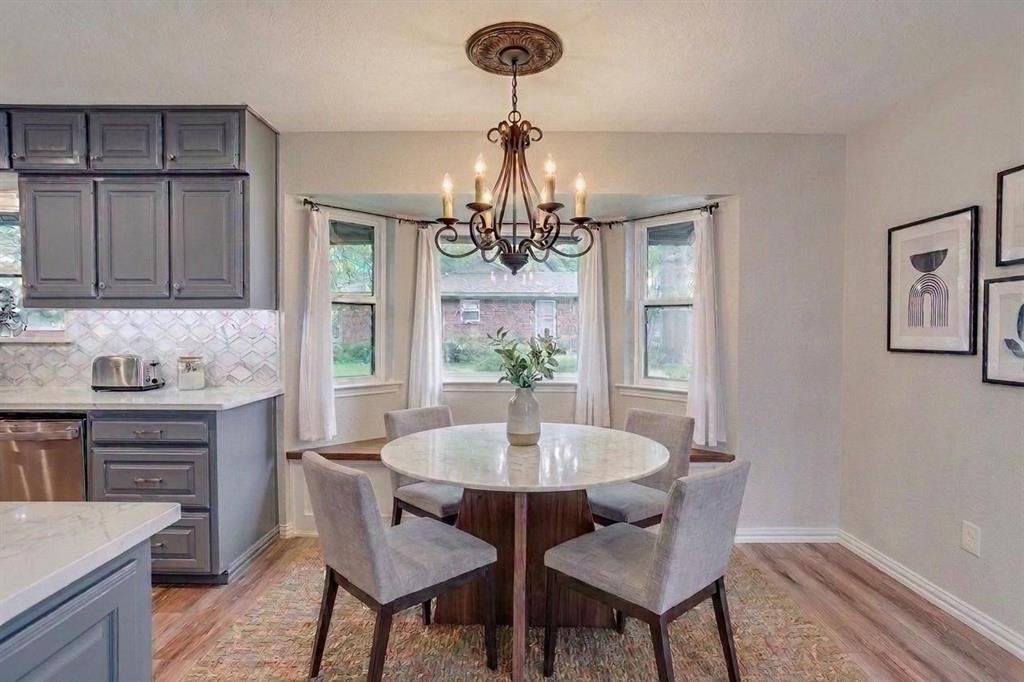 10814 Power Squadron Road Azle, TX 76020 - Photo 10 of 34 a dining room with wooden floor a chandelier a wooden table and chairs
