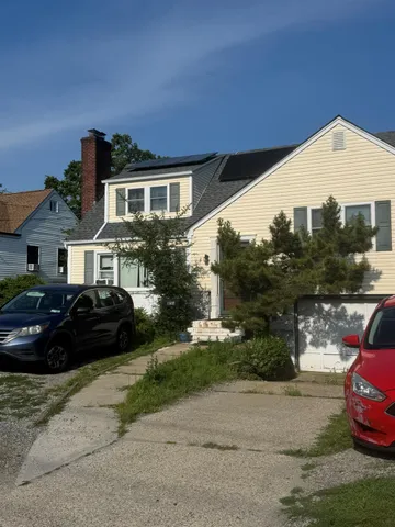 a front view of a house with a garden