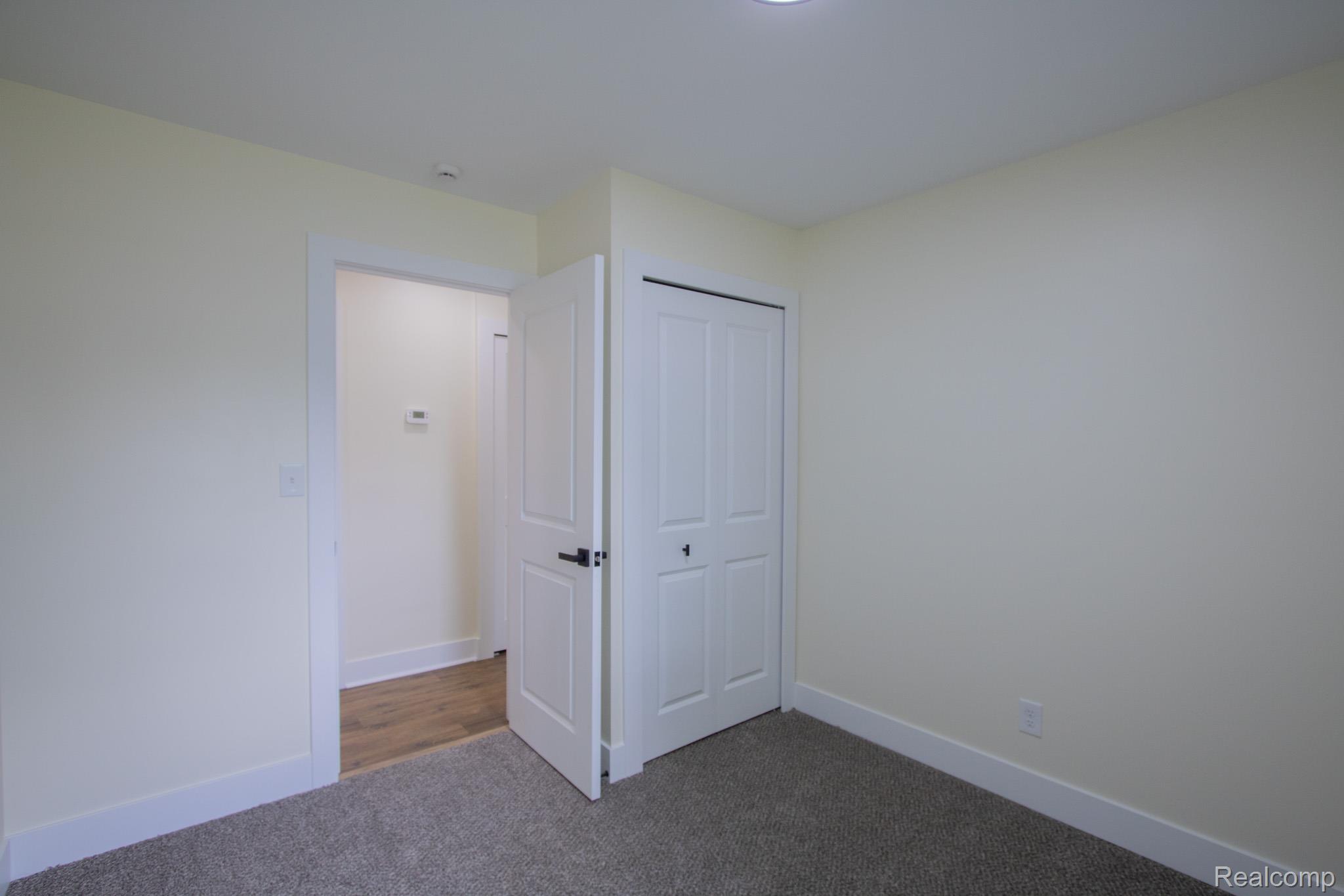 31000 Fall Fraser, MI 48026 - Photo 20 of 28 Unfurnished bedroom with dark colored carpet and a closet