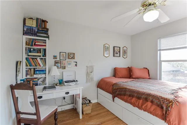 a bedroom with a bed furniture and a book shelf