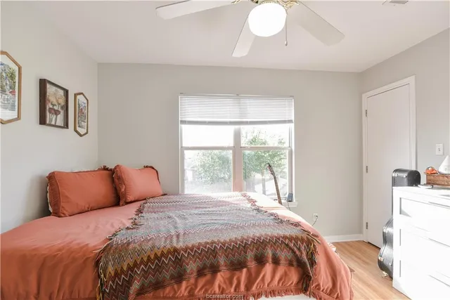 a bedroom with a bed and a window