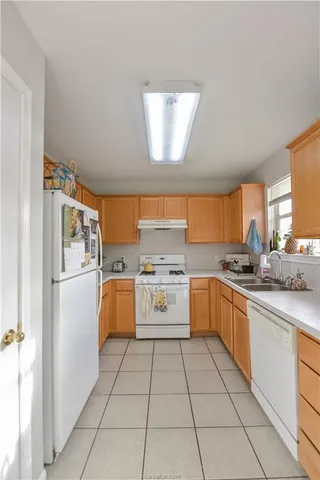 a kitchen with a stove top oven sink and cabinets