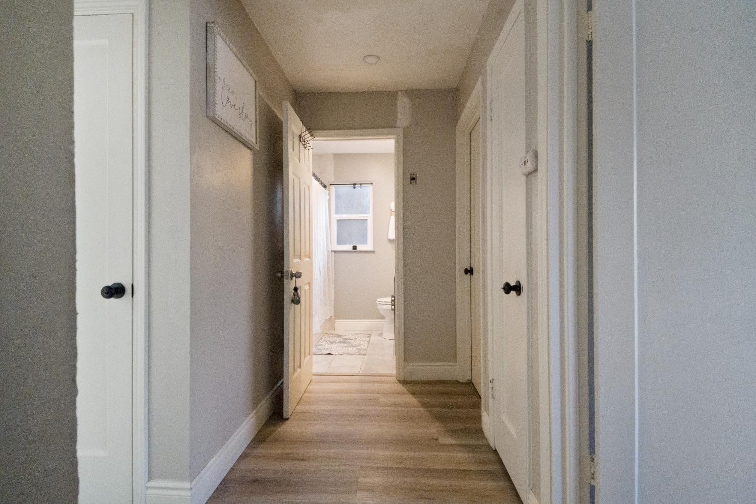 1403 East Griffith Way Fresno, CA 93704 - Photo 12 of 27 a view of a hallway with a wooden door