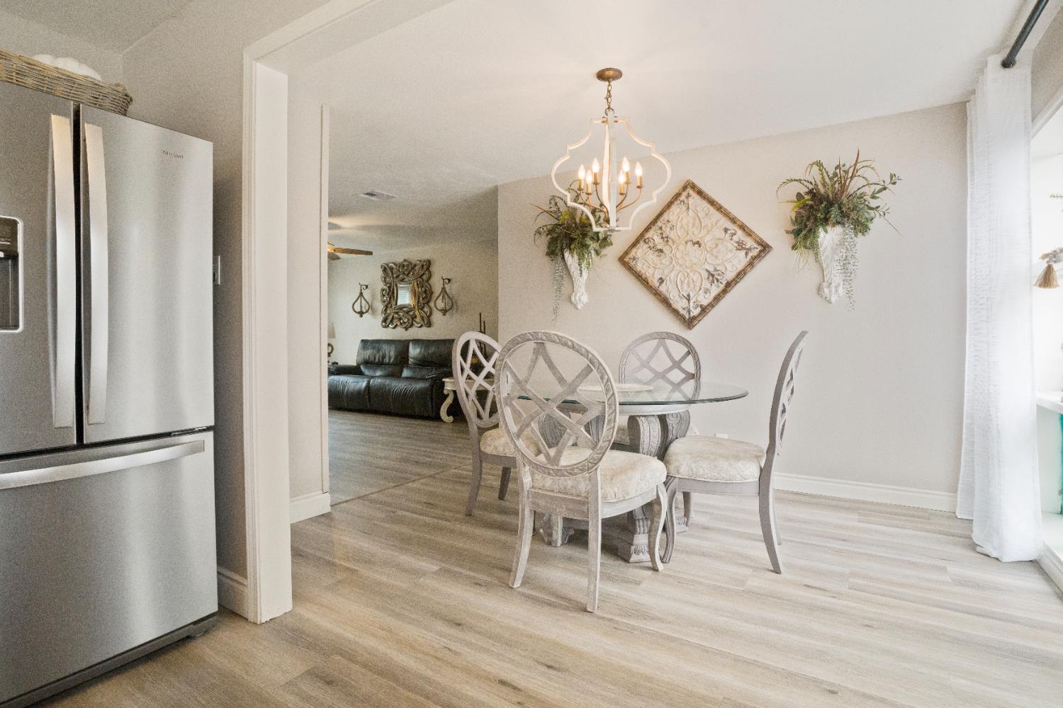 1403 East Griffith Way Fresno, CA 93704 - Photo 13 of 27 a view of a dining room with furniture wooden floor and chandelier