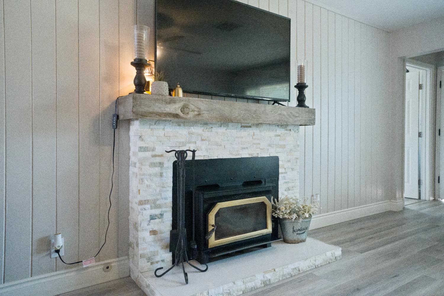 1403 East Griffith Way Fresno, CA 93704 - Photo 16 of 27 a room with fireplace and wooden floor