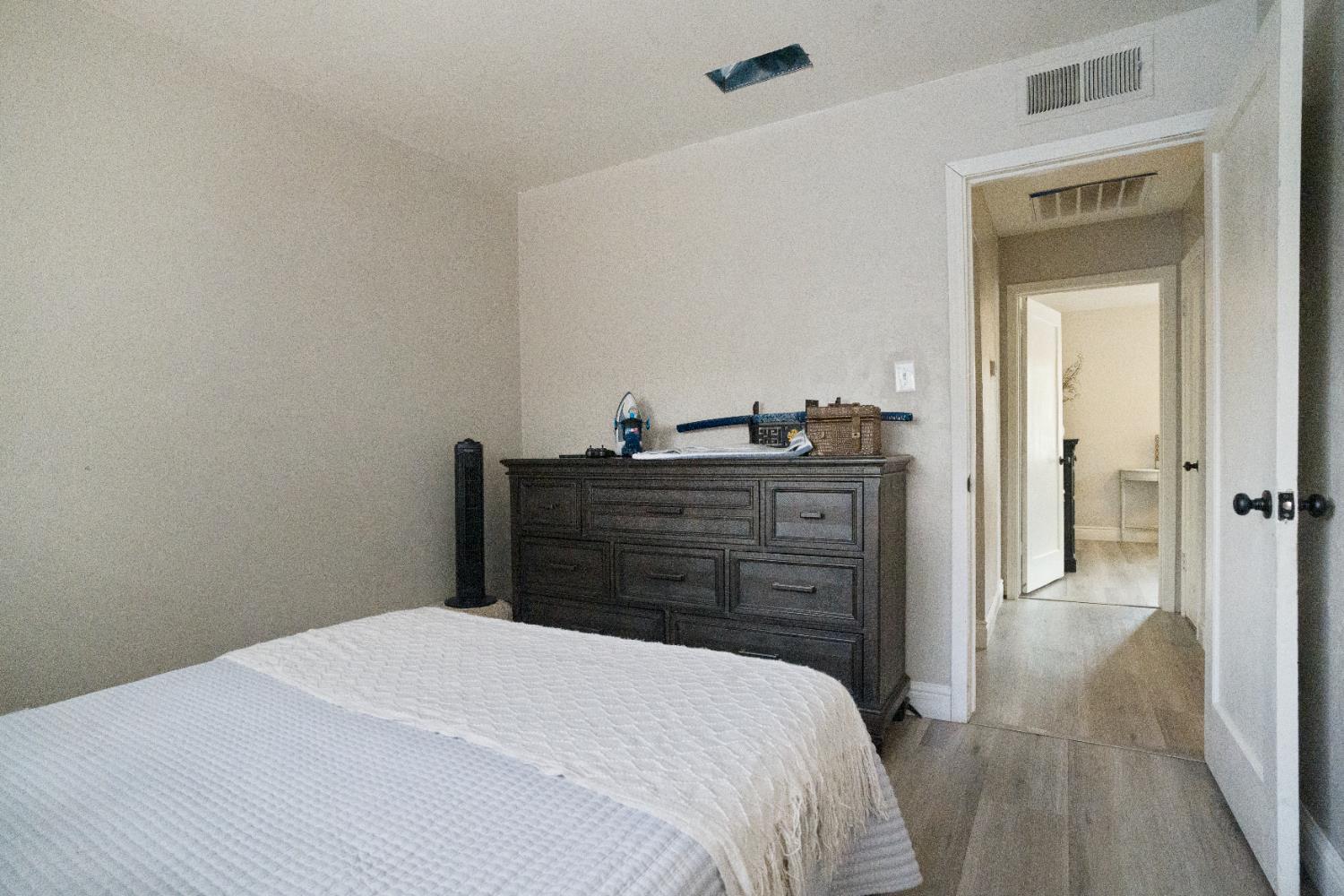 1403 East Griffith Way Fresno, CA 93704 - Photo 17 of 27 a bedroom with a bed and a dresser
