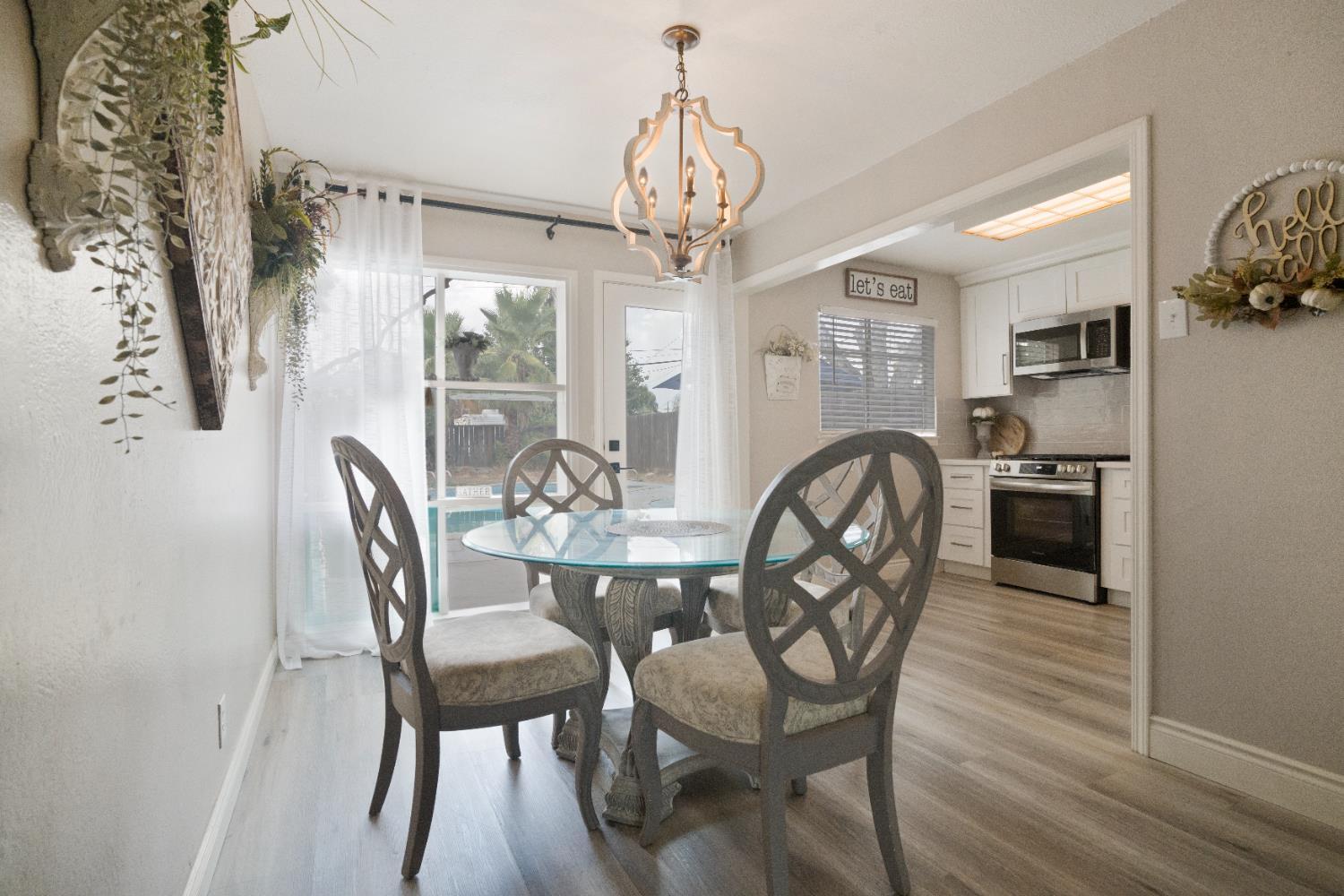 1403 East Griffith Way Fresno, CA 93704 - Photo 20 of 27 a view of a dining room with furniture and wooden floor