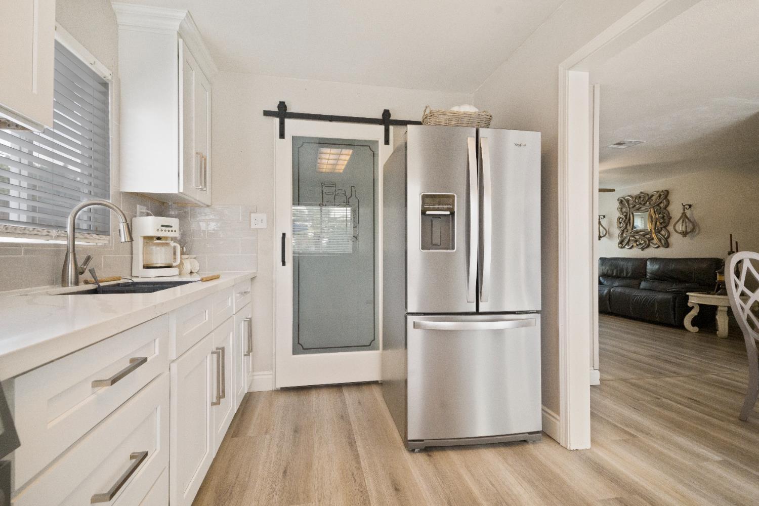1403 East Griffith Way Fresno, CA 93704 - Photo 24 of 27 a kitchen with stainless steel appliances a refrigerator sink and cabinets
